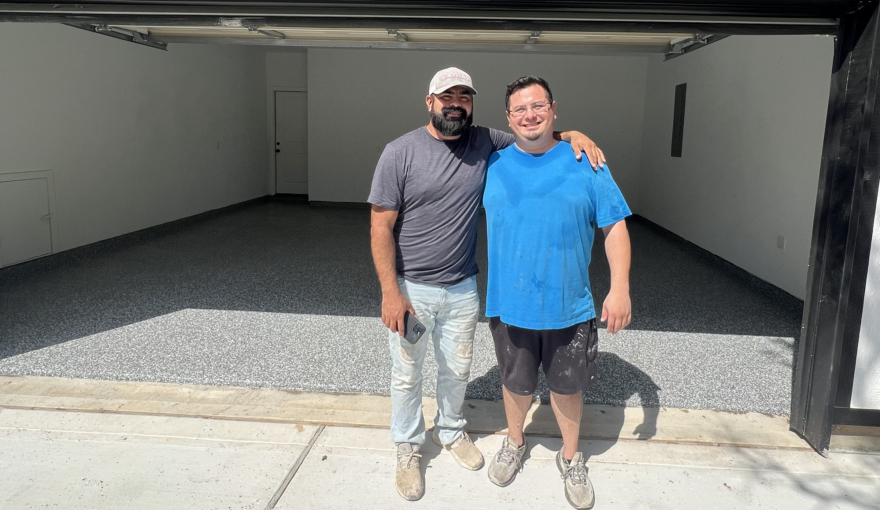 Andy and his brother after completing a garage floor coating project in Texas