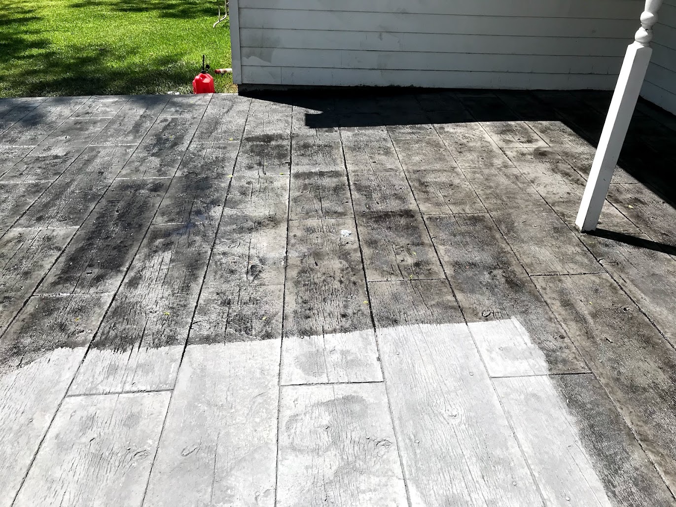 Faded stamped concrete patio in Dallas needing resealing